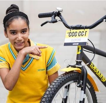 Girl with 100 000th bike from Qhubeka blog image